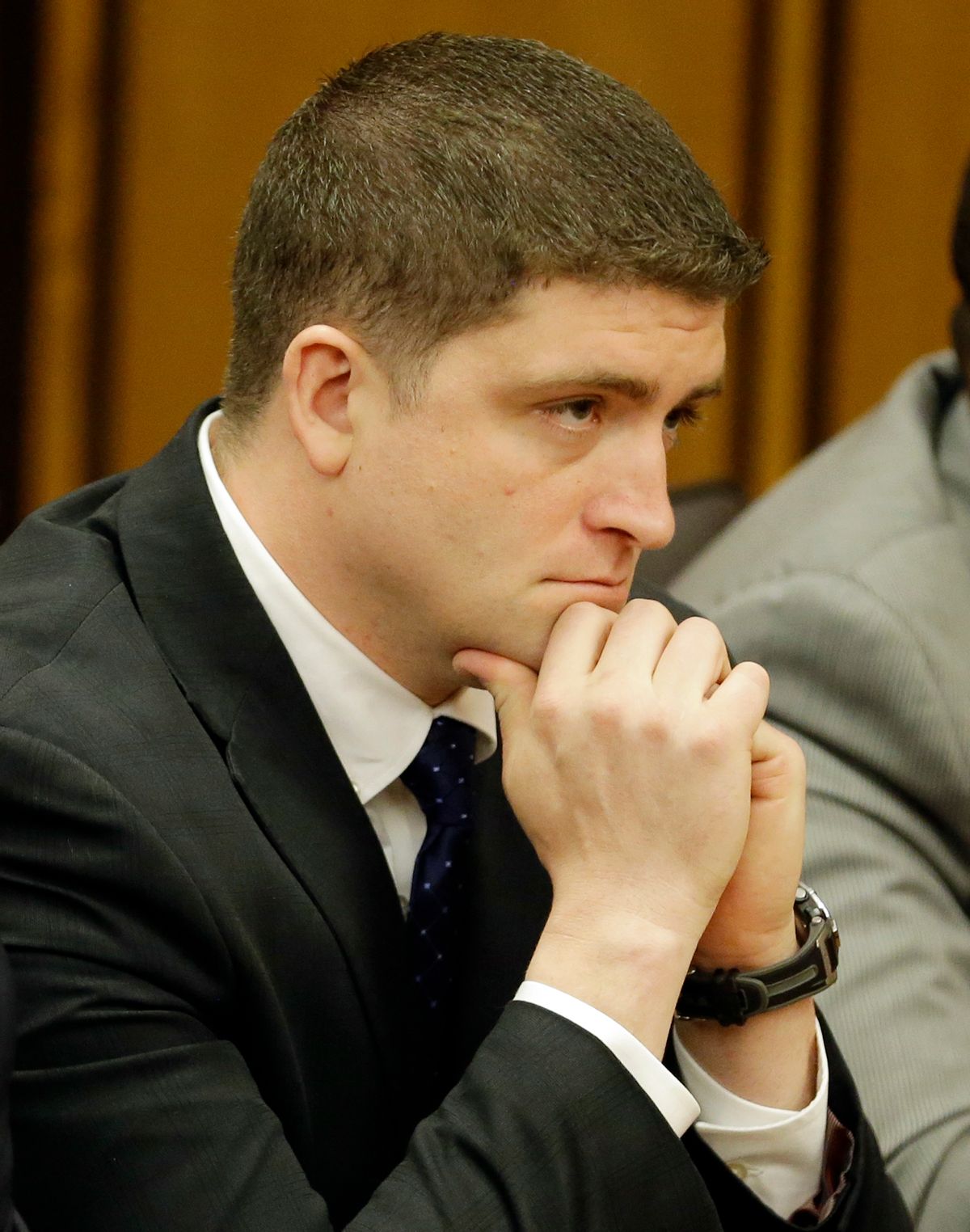 Michael Brelo listens to the judge read his verdict Saturday, May 23, 2015, in Cleveland. Brelo, a patrolman charged in the shooting deaths of two unarmed suspects during a 137-shot barrage of gunfire was acquitted Saturday in a case that helped prompt the U.S. Department of Justice determine the city police department had a history of using excessive force and violating civil rights. (AP Photo/Tony Dejak) (AP)