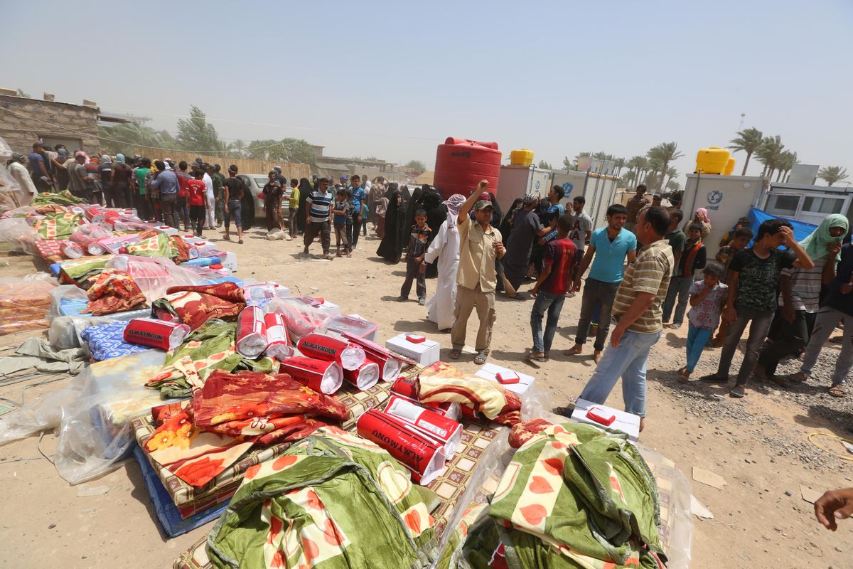 Displaced civilians from Ramadi wait to receive humanitarian aid from the United Nations in a camp in the town of Amiriyat al-Fallujah, west of Baghdad, Iraq, Friday, May 22, 2015. The United Nations World Food Program said it is rushing food assistance into Anbar to help tens of thousands of residents who have fled Ramadi after it was taken by Islamic State militant group. (AP Photo/Hadi Mizban) (AP)