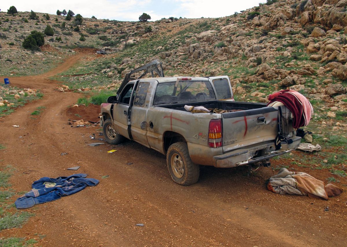 This Saturday, May 9, 2015 photo shows a damaged SUV left behind by members of the Nusra Front, al-Qaida's branch in Syria, in a position captured by Lebanon's Hezbollah fighters in the fields of the Syrian border town of Assal al-Ward. Hezbollah fighters have been spearheading an attack along with President Bashar Assad's troops against Sunni insurgents in Syria's rugged mountainous region of Qalamoun. On Saturday, Hezbollah fighters showed several local journalists and an Associated Press team positions they recently captured in Qalamoun. (AP Photo/Bassem Mroue) (AP)
