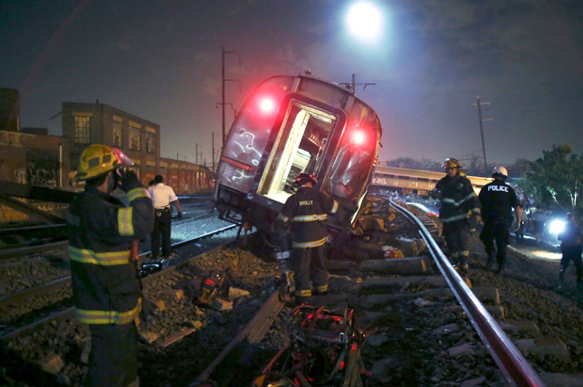 Emergency personnel work the scene of a deadly train wreck, Tuesday, May 12, 2015, in Philadelphia.      (AP/Joseph Kaczmarek)