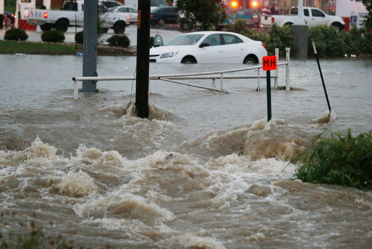 A motorist is rescued from a car trapped at a low spot near  an  intersection Monday, May 25, 2015 in Waco, Texas. Widespread flooding and trapped vehicles were reported throughout the area. (Rod Aydelotte/Waco Tribune Herald  via AP)  (AP)