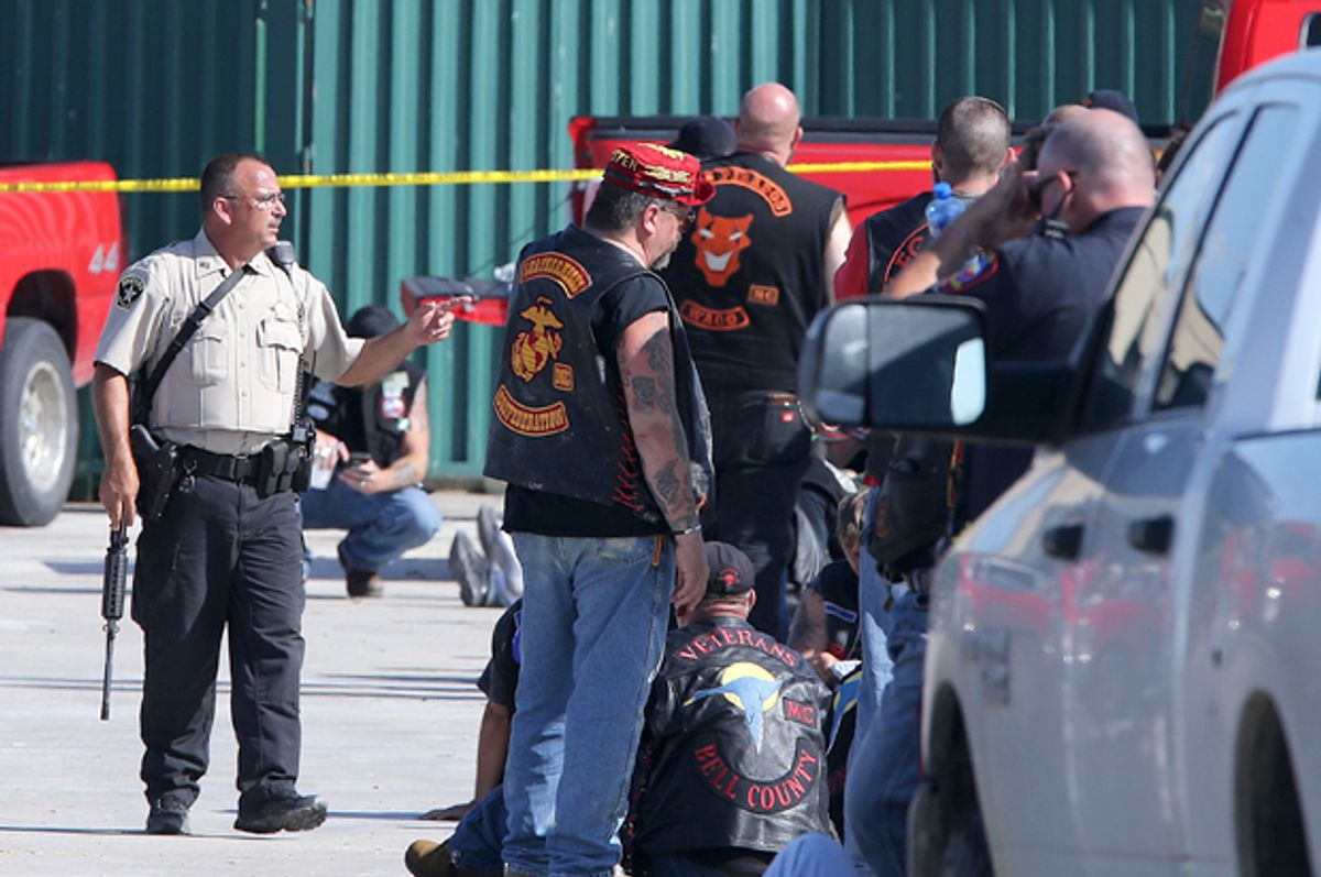 Authorities investigate a shooting in the parking lot of the Twin Peaks restaurant Sunday, May 17, 2015, in Waco, Texas.    (AP/Jerry Larson)