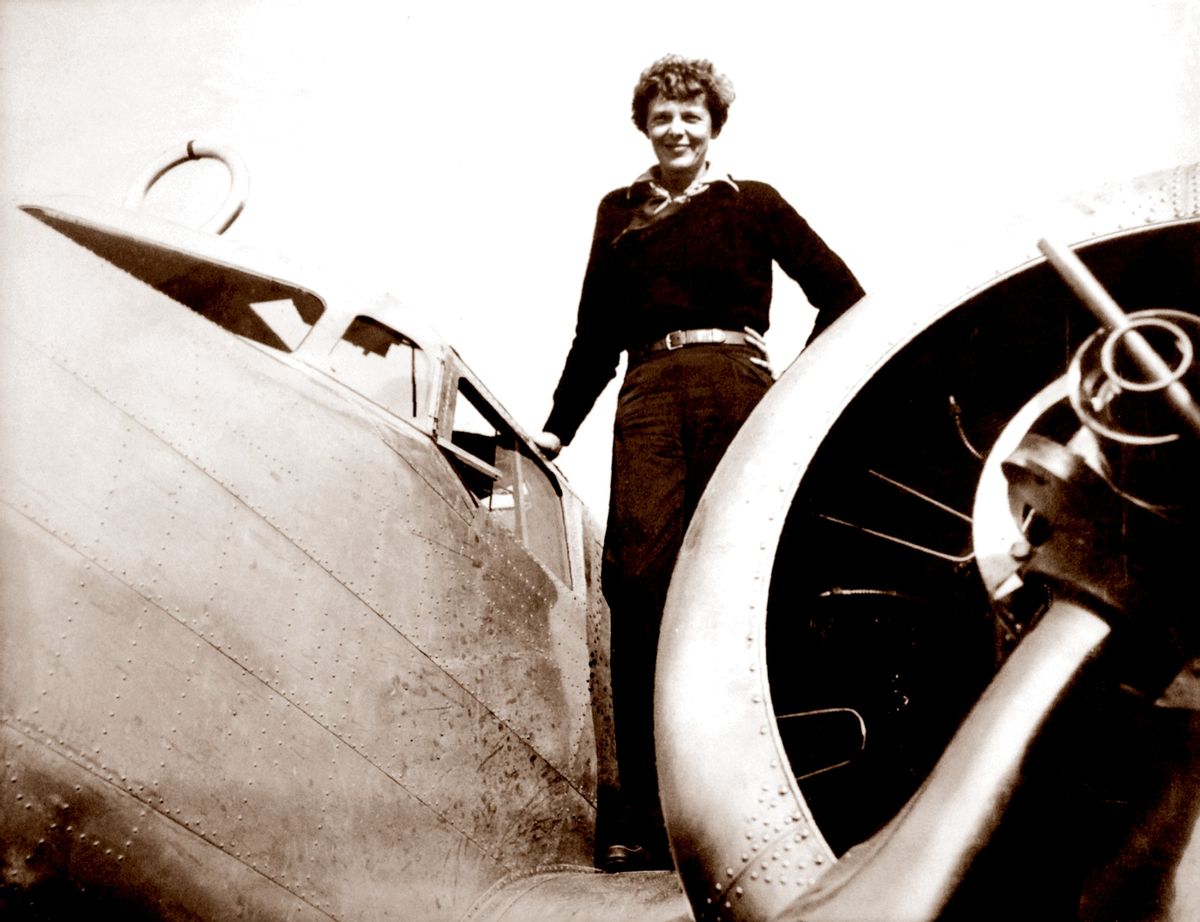 In this May 20, 1937 photo, provided by The Paragon Agency, shows aviator Amelia Earhart on the wing of her Electra plane. (Albert Bresnik/The Paragon Agency via AP)