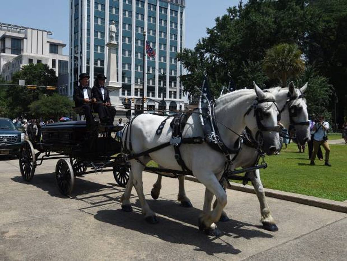 Sen. Clementa Pinckney's body arrives by horse drawn carriage at the South Carolina Statehouse, Wednesday, June 24, 2015, in Columbia, S.C.  (AP/Rainier Ehrhardt)