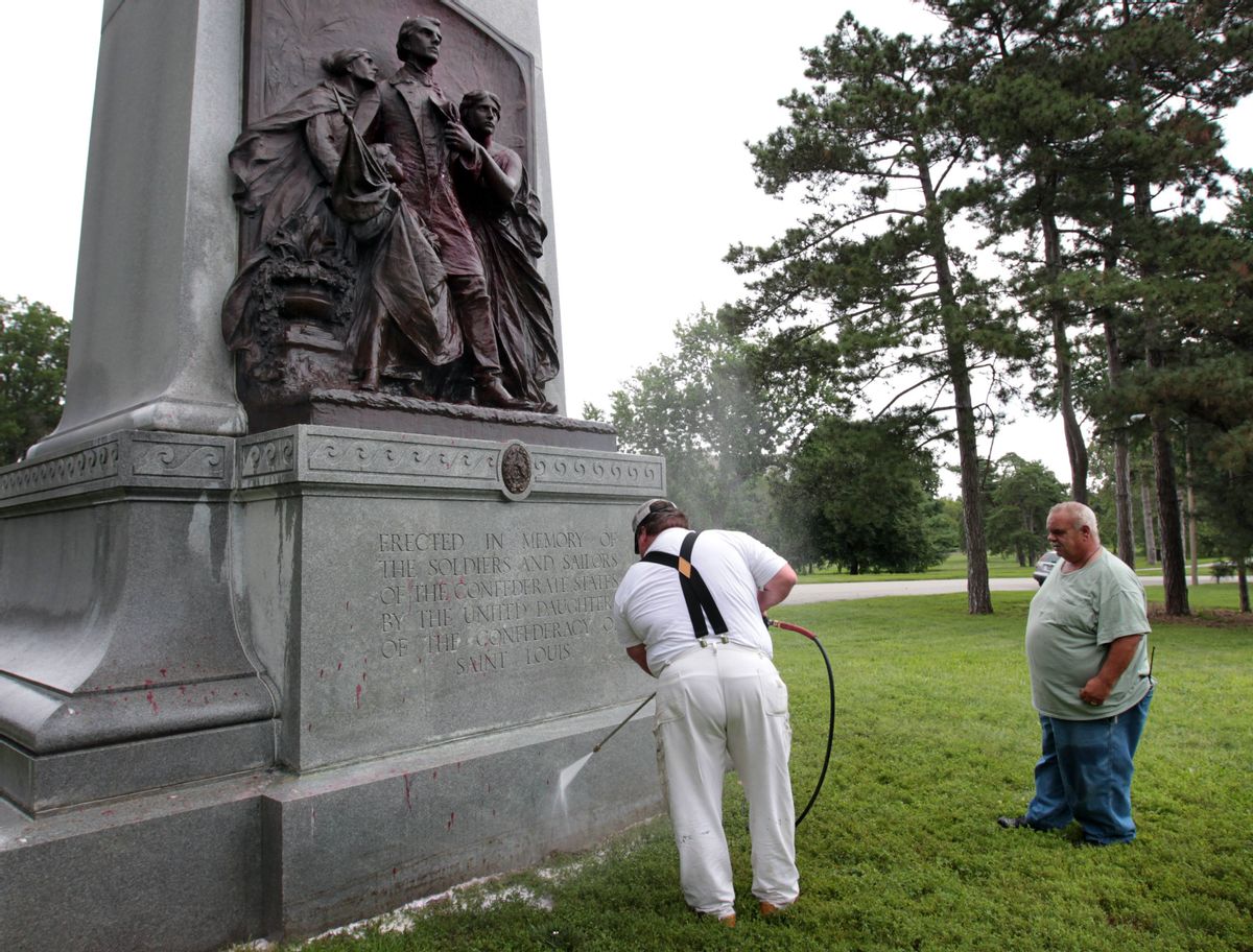 FILE - In this June 24, 2015, file photo, St. Louis Parks workers clean a Confederate memorial in St. Louis after it was spray painted with the words, "Black lives matter." Confederate monuments in a half-dozen places this week have been defaced _ a telling sign of the racial tension that permeates post-Ferguson America. (David Carson/St. Louis Post-Dispatch via AP, File) MANDATORY CREDIT; EDWARDSVILLE INTELLIGENCER OUT; THE ALTON TELEGRAPH OUT (AP)