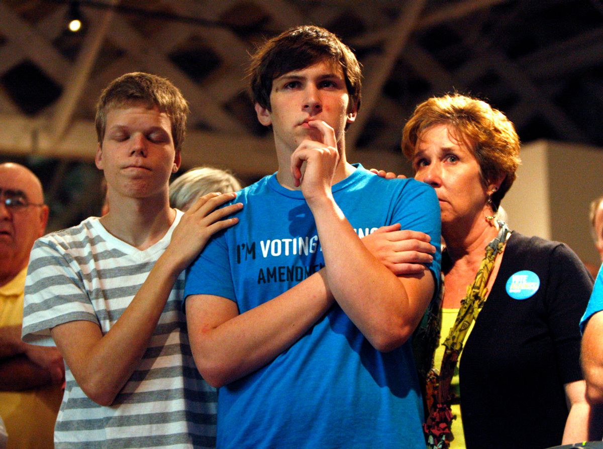 FILE - In this Tuesday, May 8, 2012 file photo, Seth Keel, center, is consoled by his boyfriend, Ian Chambers, left, and his mother Jill Hinton, during a concession speech at an Amendment One opposition party at The Stockroom at 230 in downtown Raleigh, N.C. North Carolina voters approved the constitutional amendment Tuesday defining marriage solely as a union between a man and a woman. But on Friday, June 26, 2015, the U.S. Supreme Court legalized gay marriage nationwide. (Travis Long/The News &amp; Observer via AP) MANDATORY CREDIT: TRAVIS LONG/THE NEWS &amp; OBSERVER (AP)