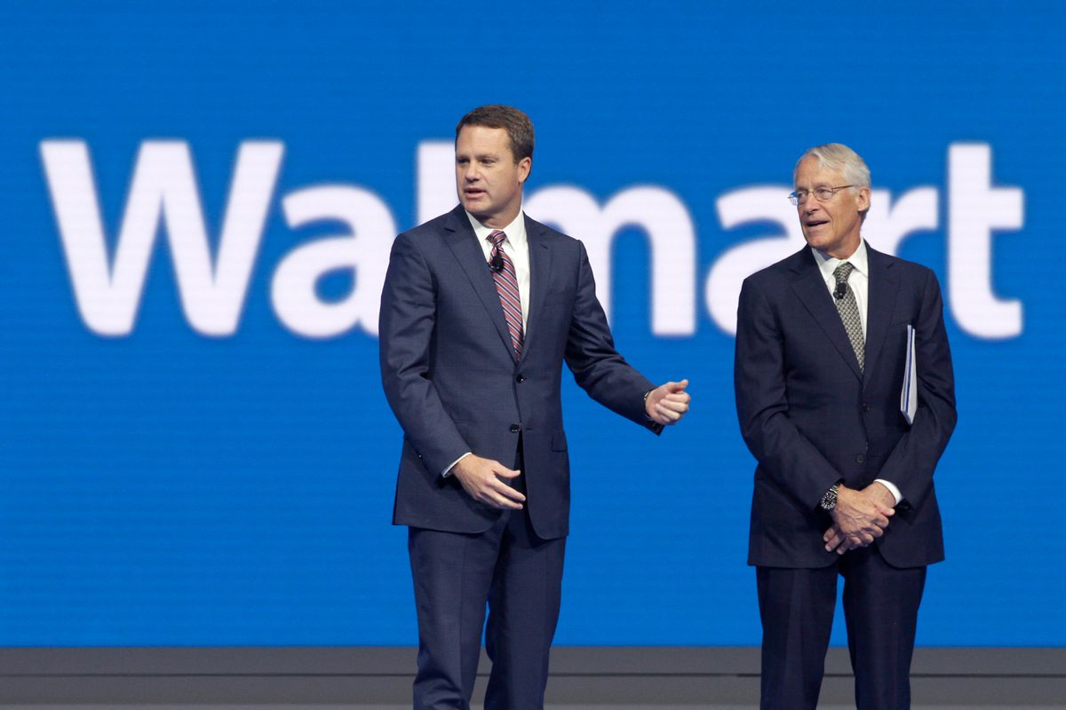 Doug McMillon, left, CEO of Wal-Mart Store, Inc., is speaks with Rob Walton, company CFO and son of Wal-Mart founder Sam Walton at the Wal-Mart shareholder meeting in Fayetteville, Ark., Friday, June 5, 2015. (AP Photo/Danny Johnston) (AP)