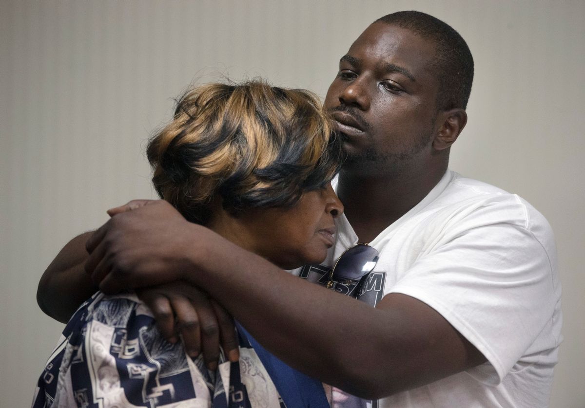 Aubrey DuBose, right, holds his mother Audrey during a news conference after murder and manslaughter charges against University of Cincinnati police officer Ray Tensing were announced for the traffic stop shooting death of motorist Samuel DuBose, Wednesday, July 29, 2015, in Cincinnati. (AP Photo/John Minchillo)  (AP)