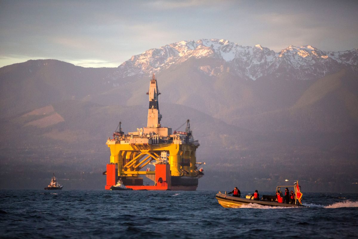 FILE - In this April 17, 2015 file photo, with the Olympic Mountains in the background, a small boat crosses in front of an oil drilling rig as it arrives in Port Angeles, Wash., aboard a transport ship after traveling across the Pacific.  (AP)