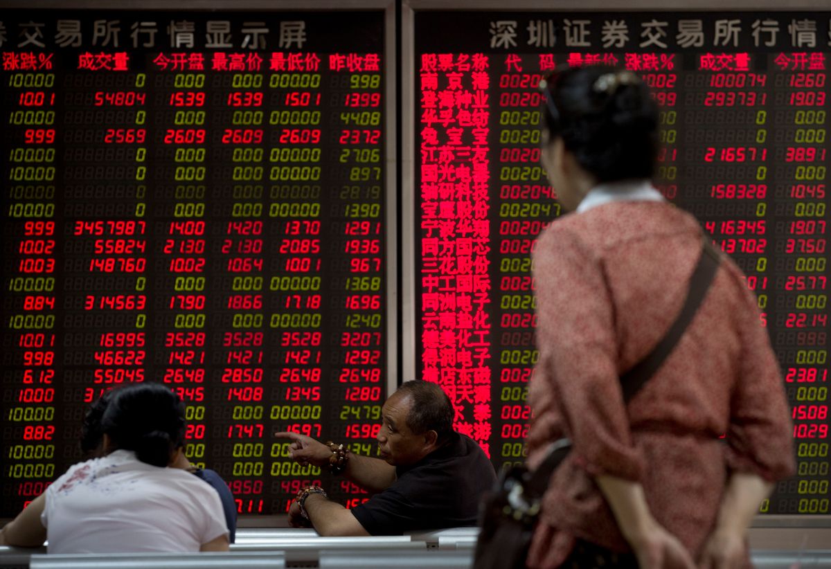 Chinese investors chat while monitoring stock prices at a brokerage house in Beijing Monday, July 13, 2015. Chinese authorities have accused securities firms of manipulating share prices and allowing improper trading during the country's market plunge, in a possible effort to deflect blame for investor losses totaling several trillion dollars. (AP Photo/Andy Wong) (AP)