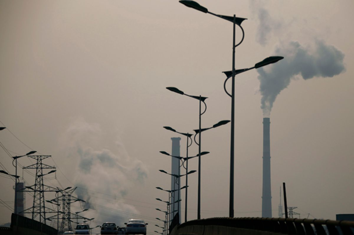 Smoke rises from chimneys of a steel plant next to a viaduct on a hazy day in Tangshan, Hebei province February 18, 2014.     (Reuters/Petar Kujundzic)