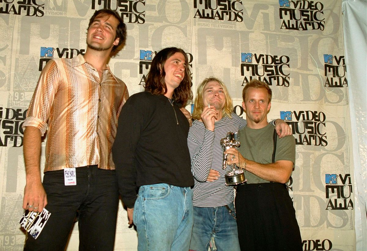 FILE - In this Sept. 2, 1993 file photo, Nirvana band members, Chris Novoselic, from left, Dave Grohl, and Kurt Cobain pose, with an unidentified man, right, after receiving an award for best alternative video for "In Bloom" at the 10th annual MTV Video Music Awards in Universal City, Calif.  Cobains widow and daughter are urging a Seattle judge not to release death-scene photos and records that a lawsuit claims will prove the Nirvana frontman was murdered more than 20 years ago. Superior Court Judge Theresa Doyle is set to hear arguments Friday, July 31, 2015, over whether to proceed with a trial after Richard Lee, who runs a Seattle public access TV show, sued the city and the Seattle Police Department for the material he says will show Cobain didnt die of a self-inflicted gunshot wound in 1994, The Seattle Times reported. (AP Photo/Mark J. Terrill, File) (AP)