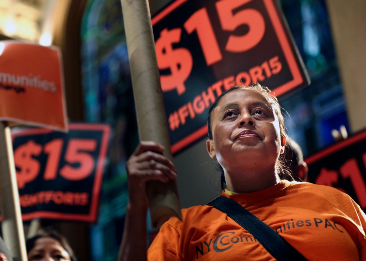 FILE - In this June 15, 2015, file photo, demonstrators rally for a $15 minimum wage before a meeting of the state Wage Board in New York. The New York state Wage Board is expected to recommend a higher minimum wage for the industry during a meeting, Wednesday, July 22, 2015, in New York City. Board members say they support an increase, though they havent offered a specific amount. (AP Photo/Seth Wenig, File) (AP)