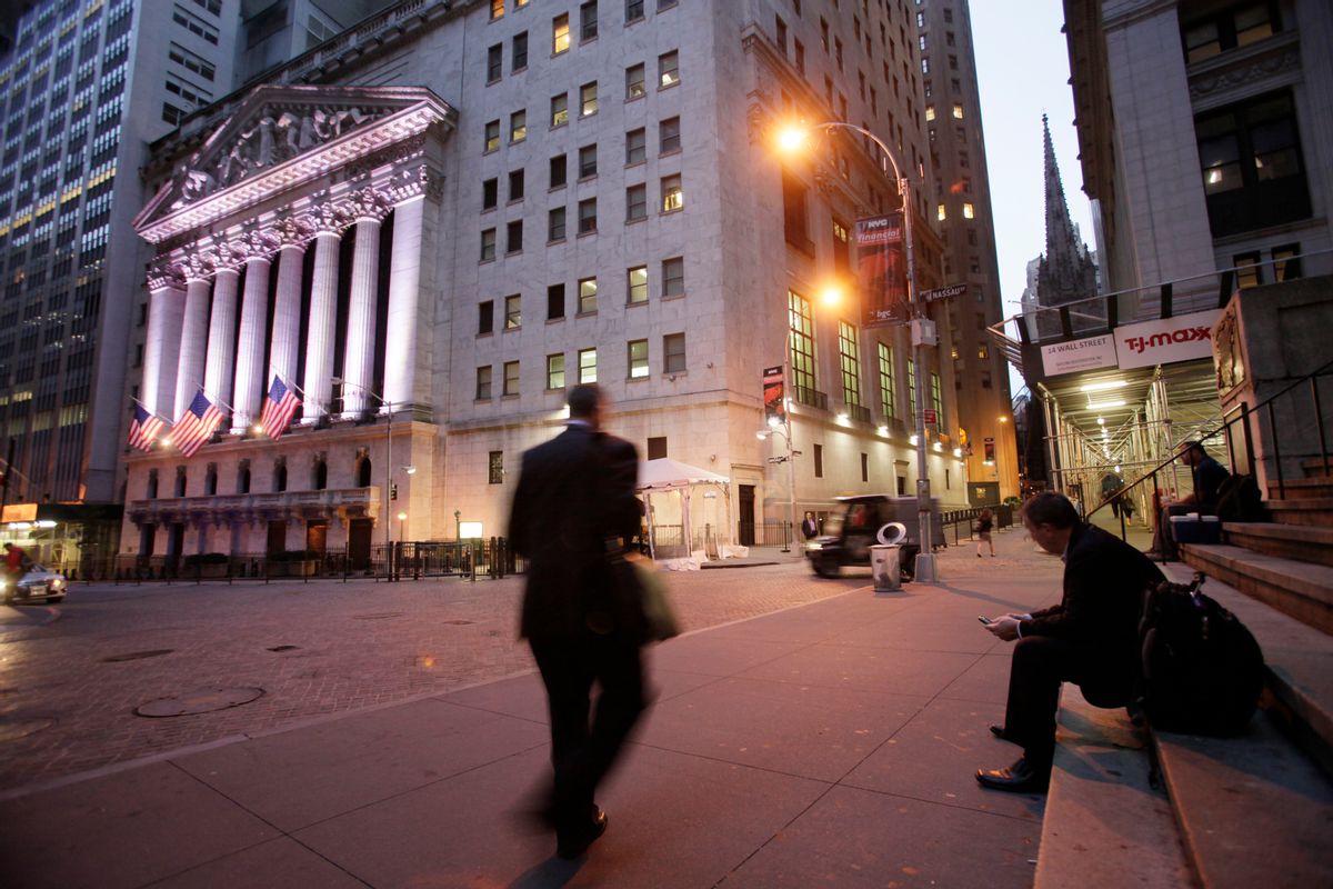 FILE - In this Oct. 8, 2014 file photo, a man walks to work on Wall Street, near the New York Stock Exchange, in New York. Global stocks were mixed on Friday, July 31, 2015, with China's stock market extending losses, after data showed the U.S. economy posted solid growth during the second quarter. (AP Photo/Mark Lennihan, File) (AP)