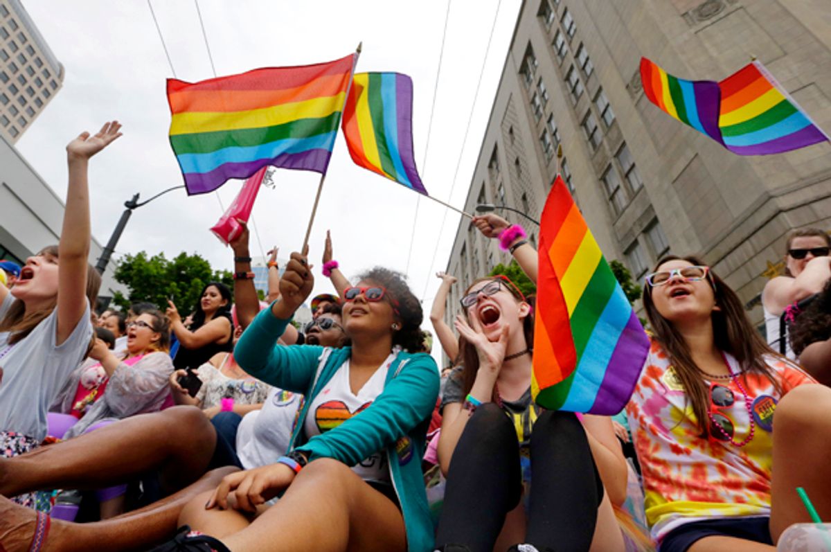 Parade viewers cheer at the 41st annual Pride Parade Sunday, June 28, 2015, in Seattle.       (AP/Elaine Thompson)