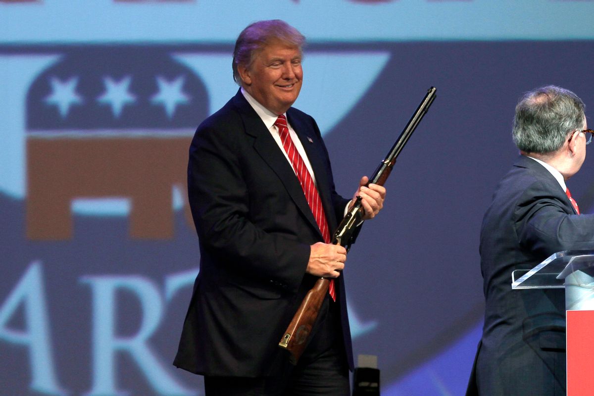 Republican presidential hopeful Donald Trump holds a Henry repeating rifle that was presented to him after speaking at the Republican Party of Arkansas Reagan Rockefeller dinner in Hot Springs, Ark., Friday, July 17, 2015. (AP Photo/Danny Johnston)  (AP Photo/Danny Johnston)