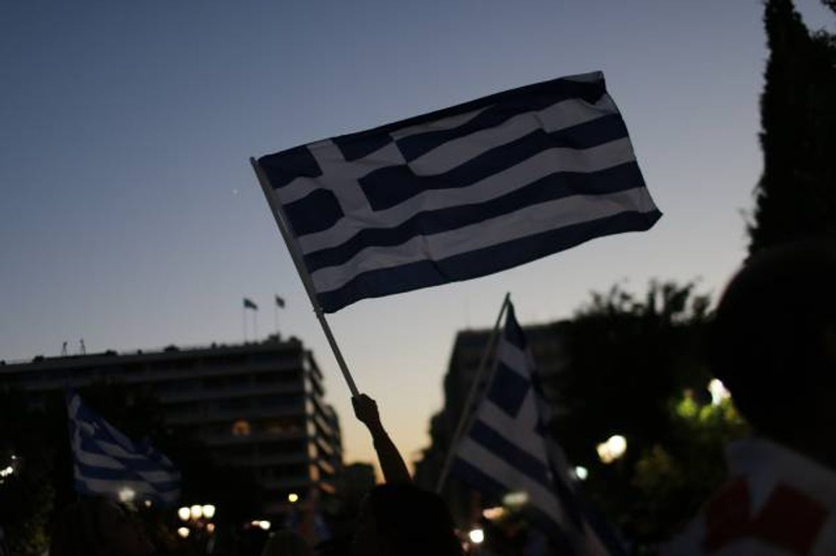 Supporters of the No vote wave Greek flags after the first results of the referendum at Syntagma square in Athens, Sunday, July 5, 2015  (AP Photo/Emilio Morenatti)