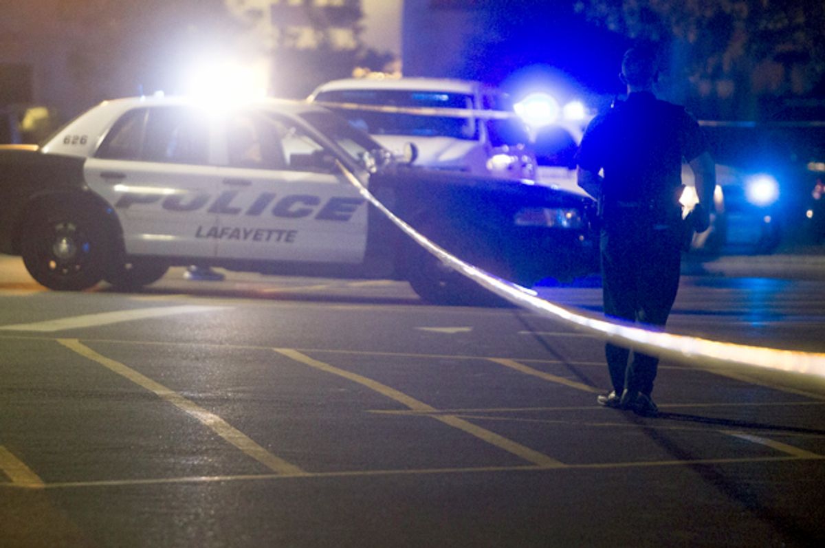 Police stand by at the scene outside the movie theatre where a man opened fire on film goers in Lafayette, Louisiana July 23, 2015.      (Reuters/Lee Celano)