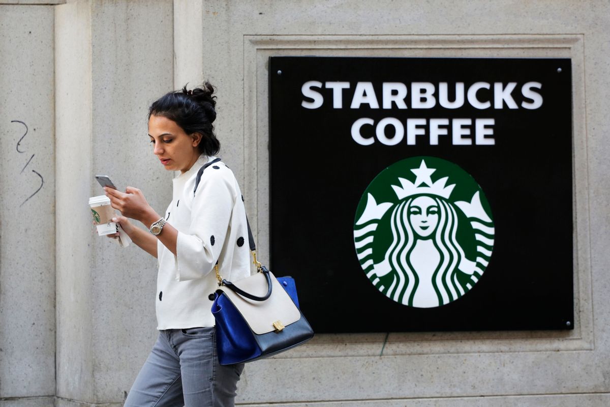 FILE- In this July 16, 2015, file photo, a woman walks out of a Starbucks Coffee with a beverage in hand in New York. Coffee prices jumped 6.1 percent in January from 12 months earlier, the most in nearly three years. Starbucks has responded by raising the price of a cup of coffee by between 5 cents and 20 cents. (AP Photo/Mark Lennihan, File) (AP)