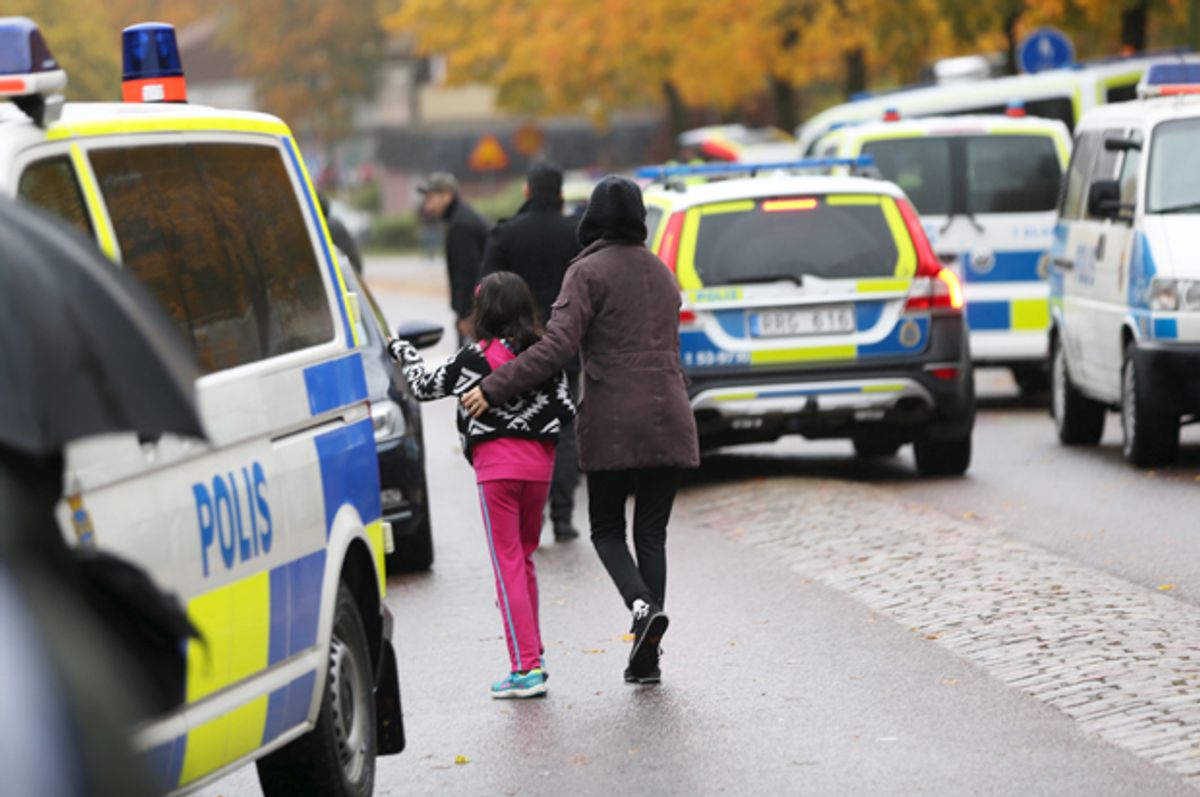 A student and her parent leave a school in Trollhattan, Sweden after a masked man killed one teacher and wounded another as well as two boys, October 22, 2015.   (Reuters/Scanpix Sweden)