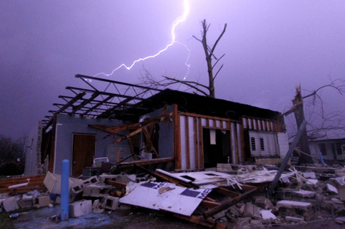Lightning illuminates a house after a tornado touched down in Jefferson County, Ala., Friday, Dec. 25, 2015.   (AP/Butch Dill)