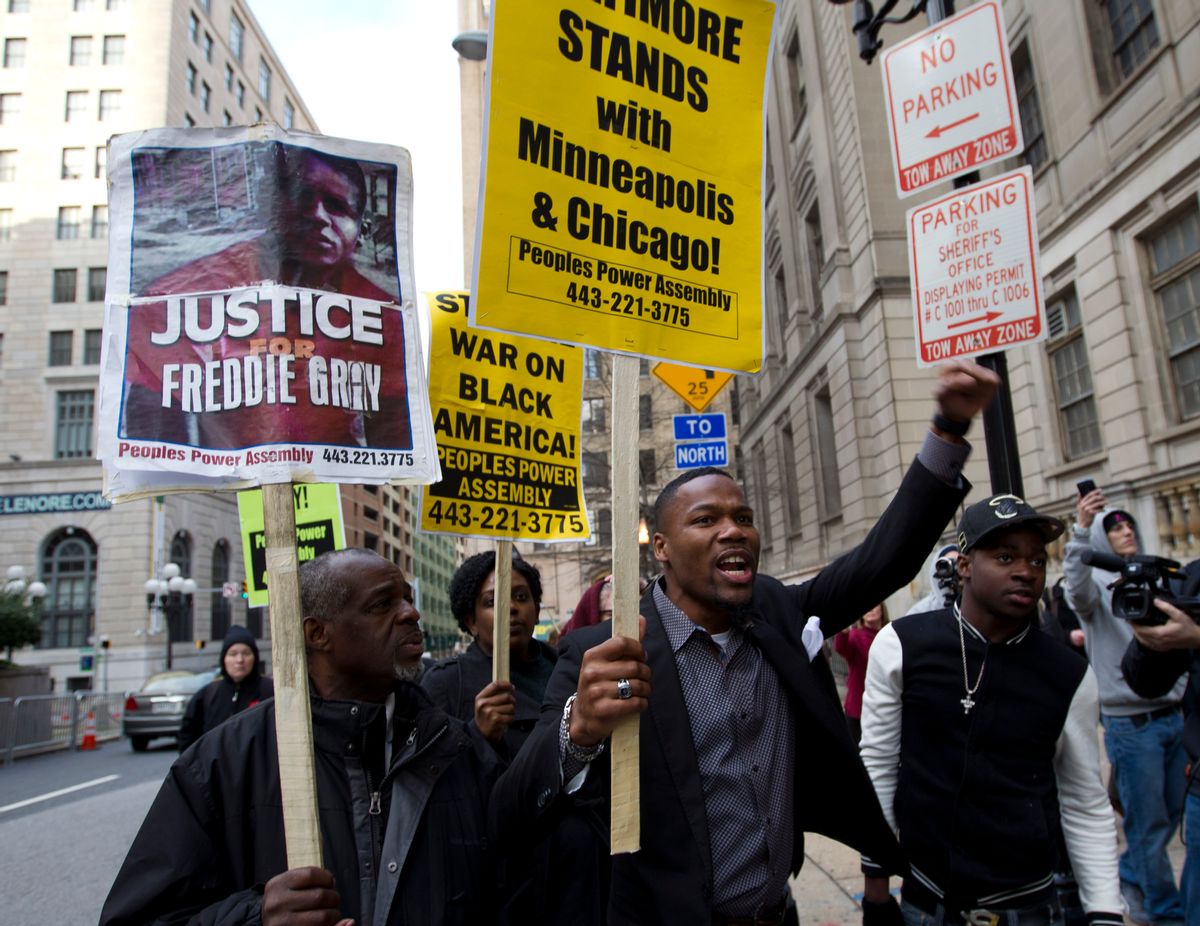 Demonstrators protest outside of the courthouse in response to a hung jury and mistrial for Officer William Porter, one of six Baltimore city police officers charged in connection to the death of Freddie Gray, Wednesday, Dec. 16, 2015, in Baltimore Md.  (AP Photo/Jose Luis Magana) (AP)