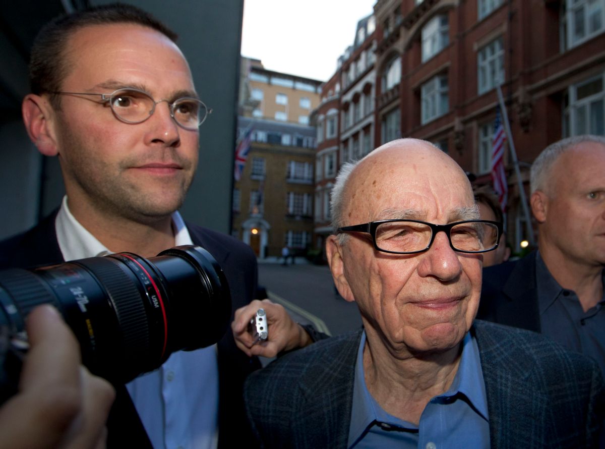 FILE - This is a  Sunday, July 10, 2011  file photo of Chairman of News Corporation Rupert Murdoch, right, and his son James Murdoch, chief executive of News Corporation Europe and Asia as they arrive at his residence in central London.  British prosecutors say Rupert Murdoch's British newspapers won't face corporate charges over phone hacking, ending a four-year investigation into tabloid wrongdoing.  (AP Photo/Sang Tan, File) (AP)