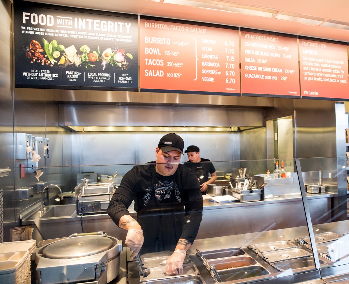 FILE - In this Dec. 15, 2015, file photo, a Chipotle Mexican Grill employee prepares food, in Seattle. After an E. coli outbreak that sickened more than 50 people, Chipotle is changing its cooking methods to prevent the nightmare situation from happening again. (AP Photo/Stephen Brashear, File) (AP)