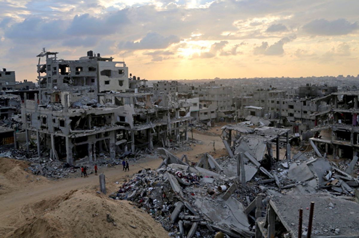 Palestinians walk through the rubble of their homes in October 2014 in Shuja'iyya, Gaza, after Israel's U.S.-backed bombing  (AP/Adel Hana)
