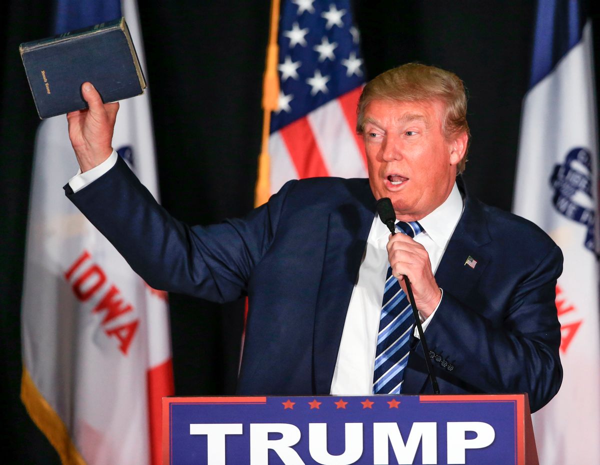 Republican presidential candidate Donald Trump holds up his Bible during a campaign stop in Council Bluffs, Iowa, Tuesday, Dec. 29, 2015. (AP Photo/Nati Harnik) (AP)