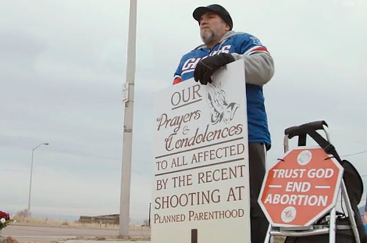 Anti-abortion protester Joseph Martone stands outside Planned Parenthood, Colorado Springs, Co.   (theguardian.com)