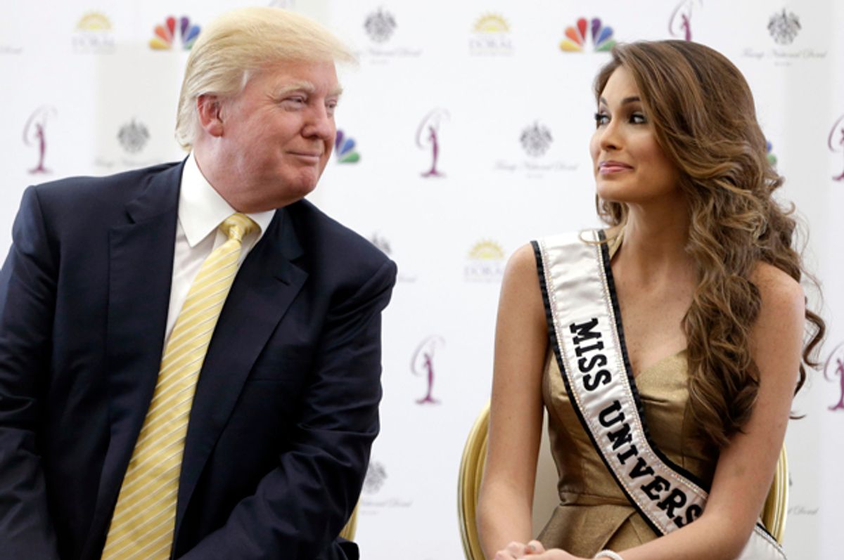 Donald Trump and Miss Universe, Gabriela Isler, of Venezuela, talk during a news conference, Thursday, Oct. 2, 2014, in Doral, Fla.   (AP/Wilfredo Lee)