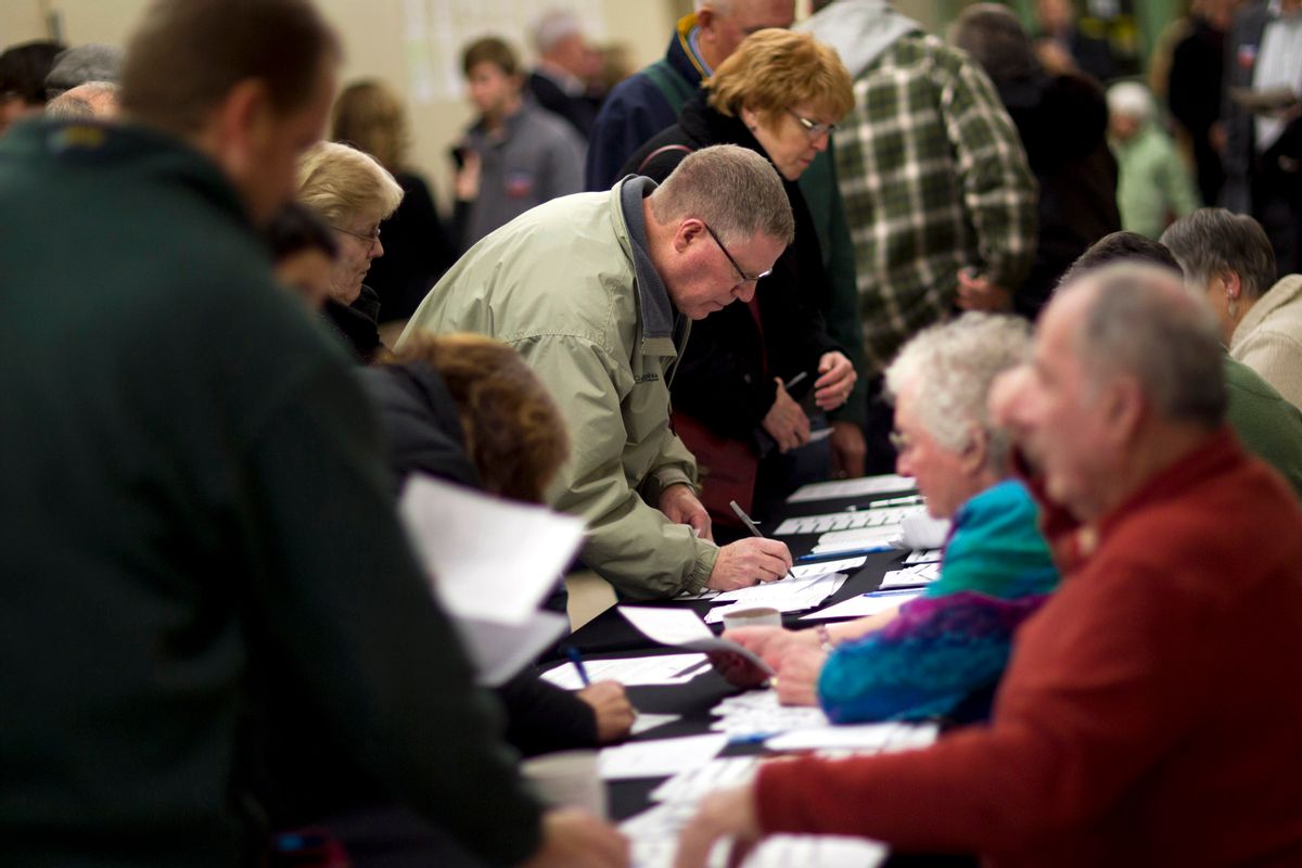 FILE - In this Jan. 3, 2012 file photo, voters sign in on caucus night at Point of Grace Church in Waukee, Iowa. More than 40 years ago, a scheduling quirk vaulted Iowa to the front of the presidential nominating process, and ever since most White House hopefuls have devoted enormous time and money to a state that otherwise would get little attention.  (AP Photo/Evan Vucci, File) (AP)