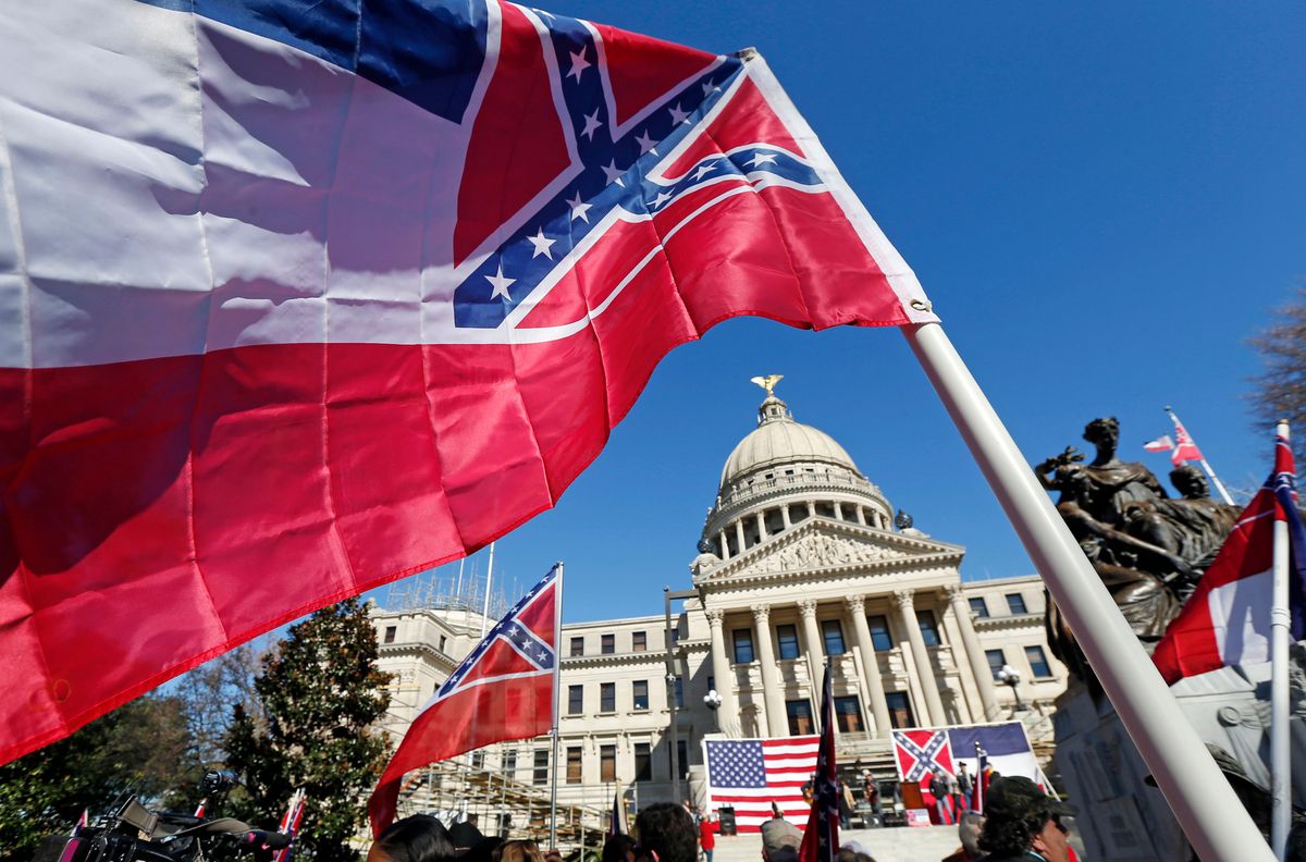 Sons of Confederate Veterans and other groups parade on the grounds of the state Capitol in Jackson, Miss., Tuesday, Jan. 19, 2016, in support of keeping the Confederate battle emblem on the state flag. The public display of Confederate symbols has come under increased scrutiny since June, when nine black worshippers were massacred at a church in South Carolina.  (AP Photo/Rogelio V. Solis) (AP)