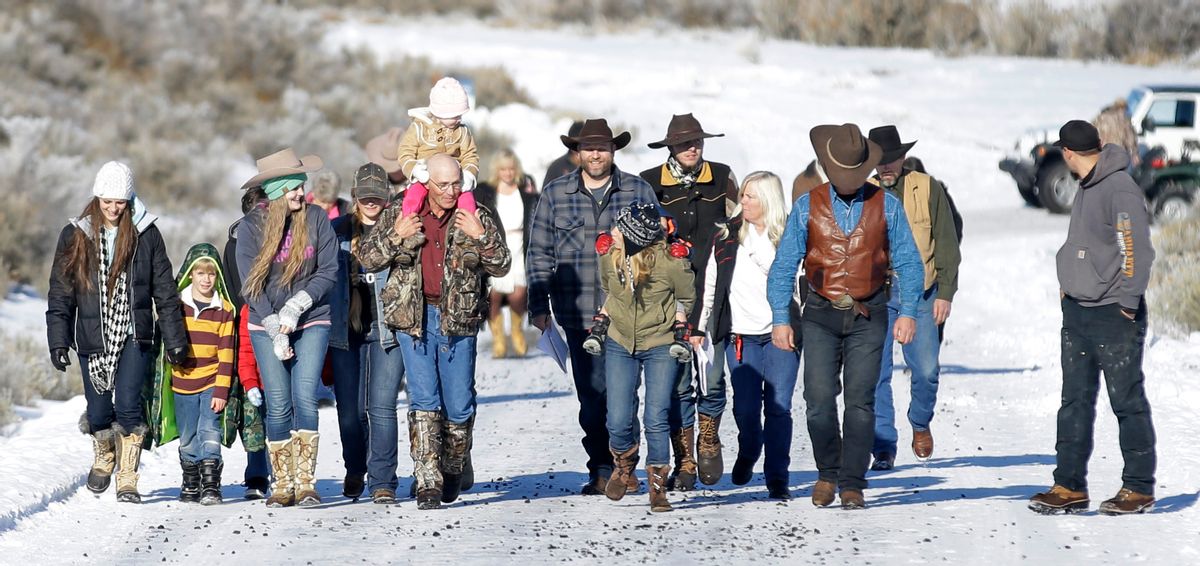 Ammon Bundy, center, one of the sons of Nevada rancher Cliven Bundy, arrives for a news conference with supporters at Malheur National Wildlife Refuge Friday, Jan. 8, 2016, near Burns, Ore. Bundy the leader of a small, armed group occupying a national wildlife refuge in Oregon says the activists have no immediate plans to leave. Bundy spoke to reporters Friday, a day after meeting with a local sheriff who asked the group to go. (AP)