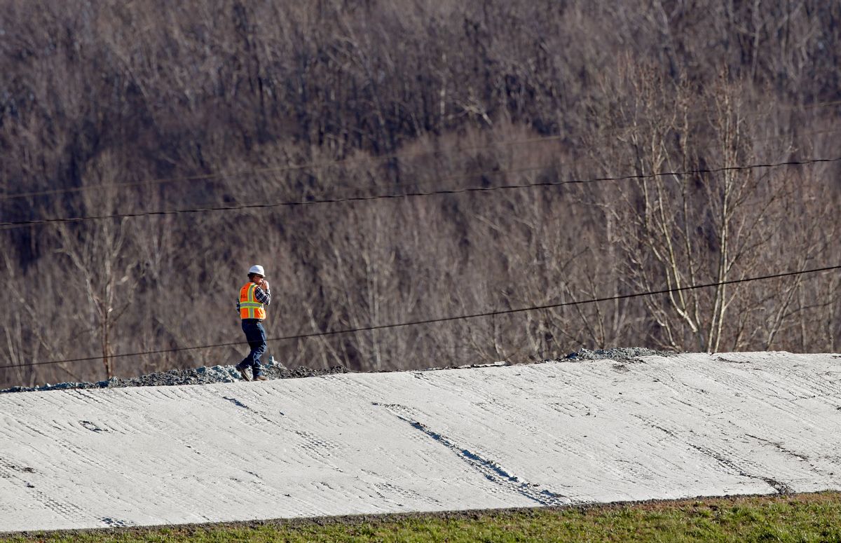 In this Thursday, Jan. 14, 2016, photo, a worker walks across an area where coal ash removal is underway at the Dan River Steam Station in Eden, N.C. Duke Energy Corp. is digging up and hauling away the toxic coal residues two years after one of the worst coal-ash spills in U.S. history. (AP Photo/Gerry Broome) (AP)