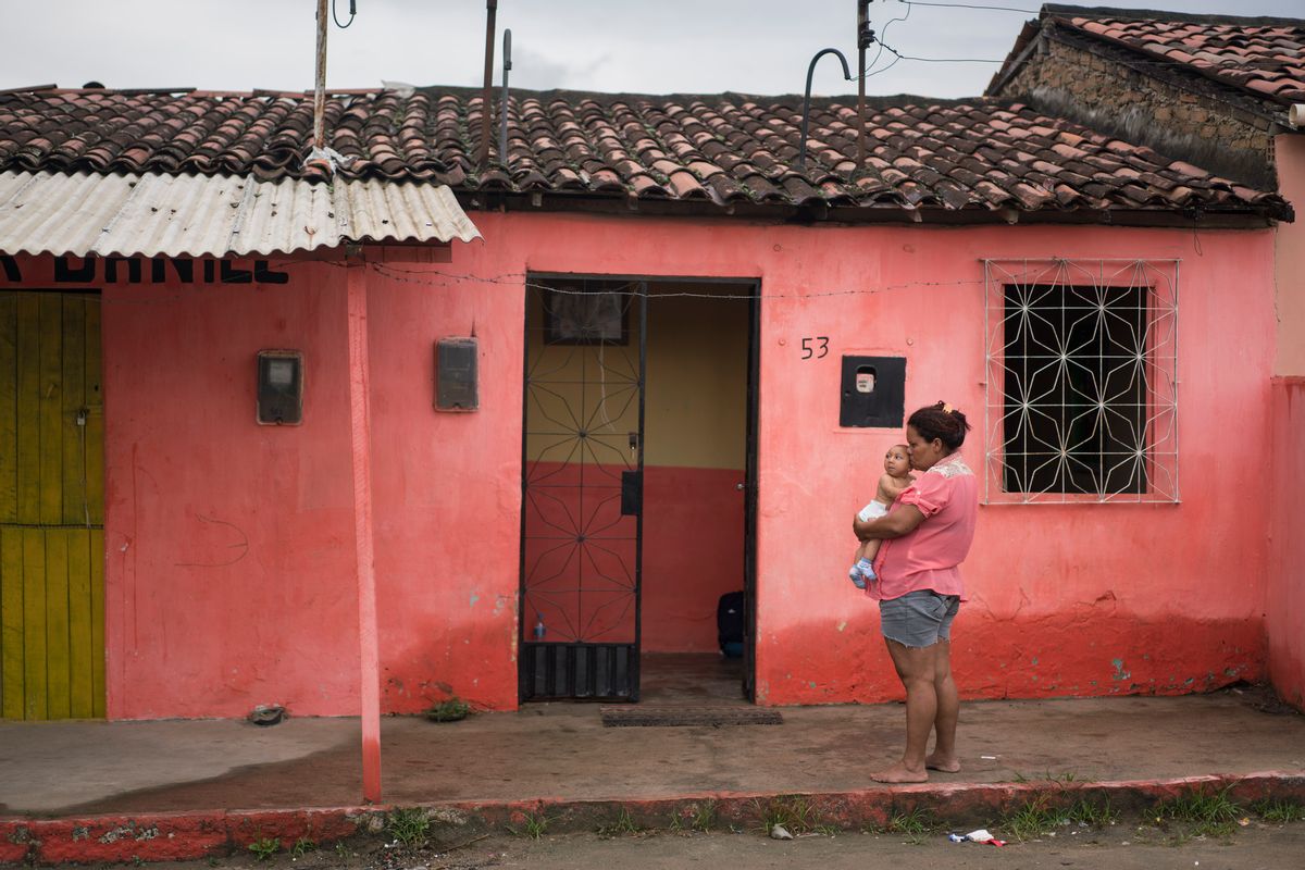 In this Jan. 30, 2016 photo, Solange Ferreira holds Jose Wesley outside their house in Bonito, Pernambuco state, Brazil.  (AP/Felipe Dana)