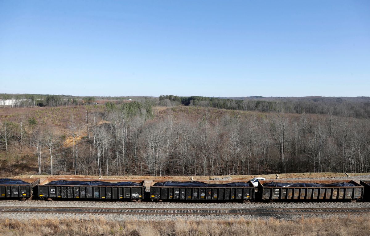 In this Thursday, Jan. 14, 2016, photo, rail cars filled with coal ash await transportation from the Dan River Steam Station in Eden, N.C.  Duke Energy Corp. is digging up and hauling away the toxic coal residues two years after one of the worst coal-ash spills in U.S. history. (AP Photo/Gerry Broome) (AP)