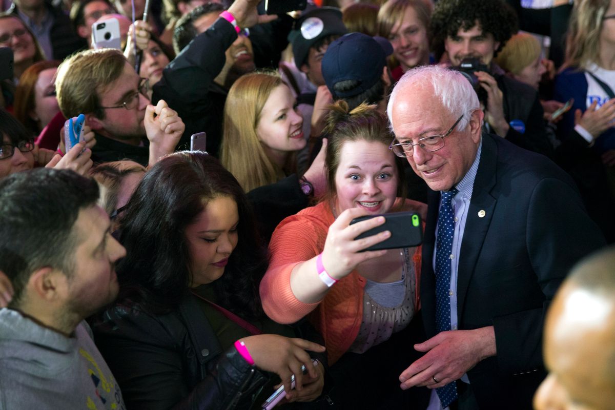 Democratic presidential candidate Sen. Bernie Sanders, I-Vt., poses for photos during a caucus night rally on Monday, Feb. 1, 2016, in Des Moines, Iowa. (AP Photo/Evan Vucci) (AP)