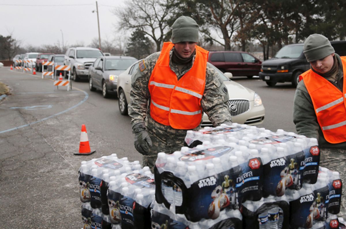Michigan National Guard members help to distribute water to residents in their cars in Flint, Michigan January 21, 2016.    (Reuters/Rebecca Cook)