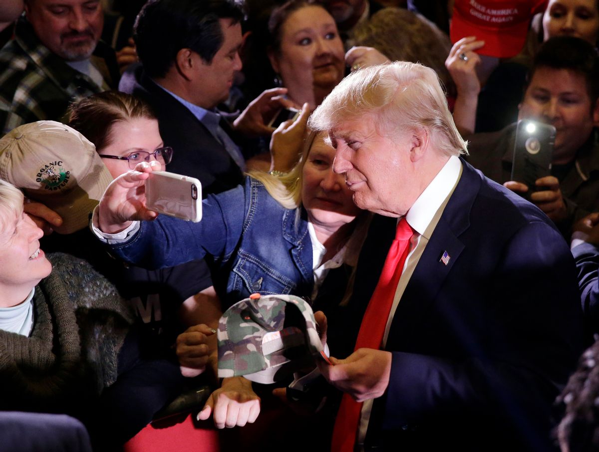 Republican presidential candidate Donald Trump takes pictures with supporters during a rally Tuesday, Feb. 23, 2016, in Reno, Nev. (AP Photo/Marcio Jose Sanchez) (AP)