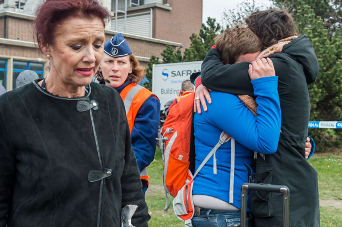 People react outside Brussels airport after explosions, March 22, 2016.    (AP/Geert Vanden Wijngaert)