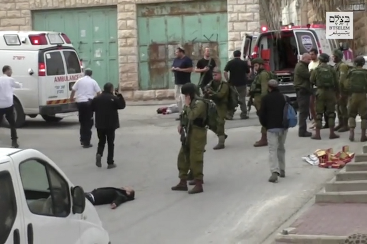 Israeli soldier points his rifle at incapacitated Palestinian man moments before extrajudicially executing him in the occupied West Bank  (YouTube/B'Tselem)
