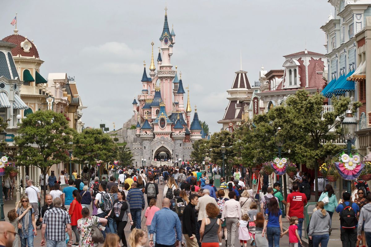 FILE - In this May 12, 2015, file photo, visitors walk near Sleeping Beauty's Castle at Disneyland Paris, in Marne la Vallee, France.(AP Photo/Michel Euler, File) (AP)