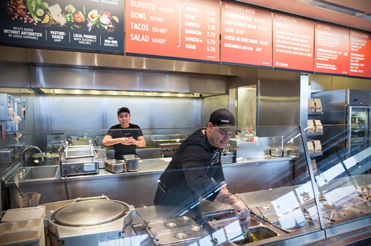 A Chipotle Mexican Grill employee prepares food, Dec. 15, 2015, in Seattle.    (AP/Stephen Brashear)