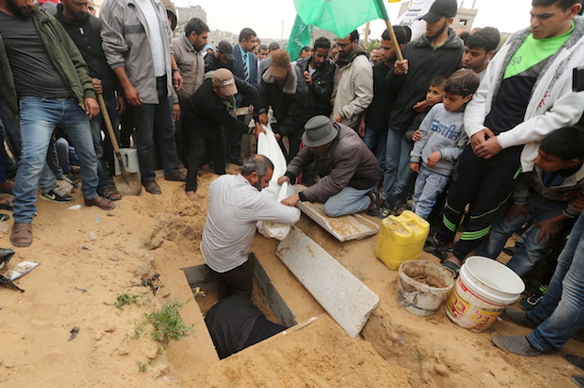 Mourners bury the body of 10-year-old Palestinian boy Yassin Abu Khoussa, who was killed by an Israeli airstrike in northern Gaza on March 12, 2016  (Reuters/Mohammed Salem)