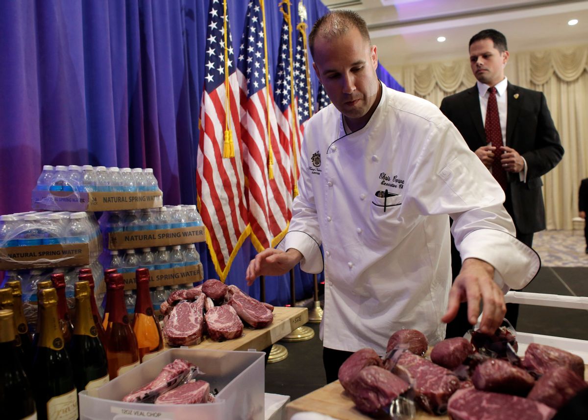 A chef with the Trump National Golf Club arranges alleged Trump steaks prior to Donald Trump's news conference on Tuesday (AP)