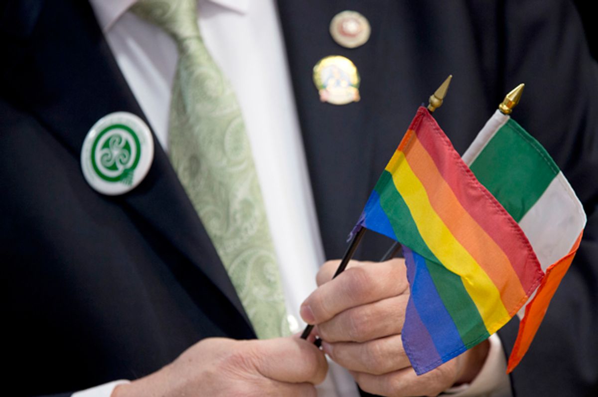 New York City Council Member Daniel Dromm holds the Irish Flag and the Gay Pride Flag during a news conference at the Irish Consulate, March 3, 2016, in New York.   (AP/Mary Altaffer)