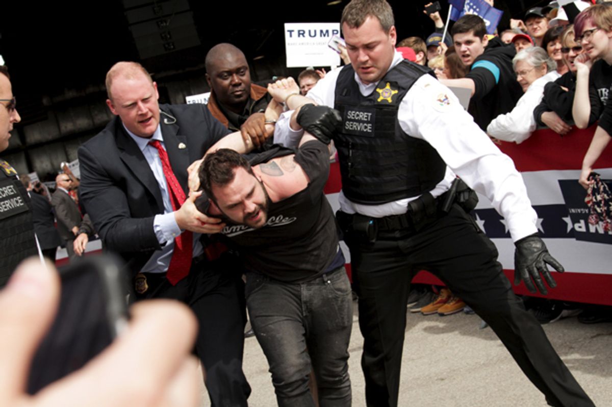 U.S. Secret Service agents detain a man after a disturbance at a Donald Trump rally in Dayton, Ohio March 12, 2016.   (Reuters/William Philpott)