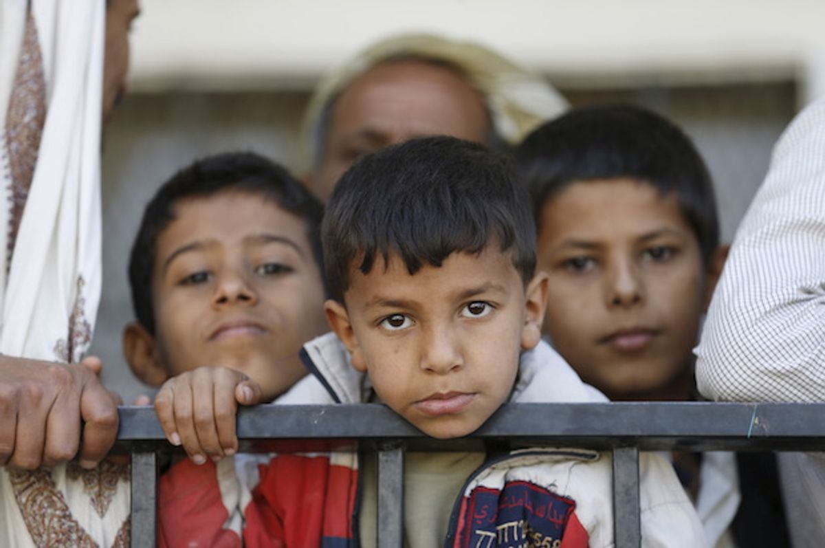 Children wait to receive food vouchers at a food distribution center for poor families in Yemen's capital Sanaa on March 17, 2016 (Reuters/Khaled Abdullah)